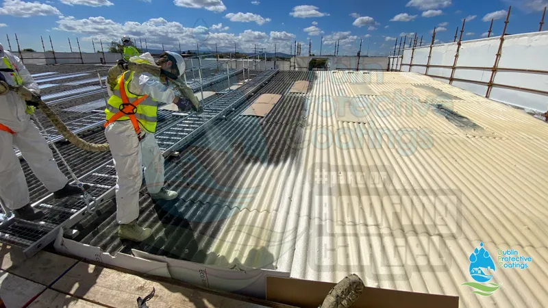 Spray-applying protective coating to a metal cladding roof